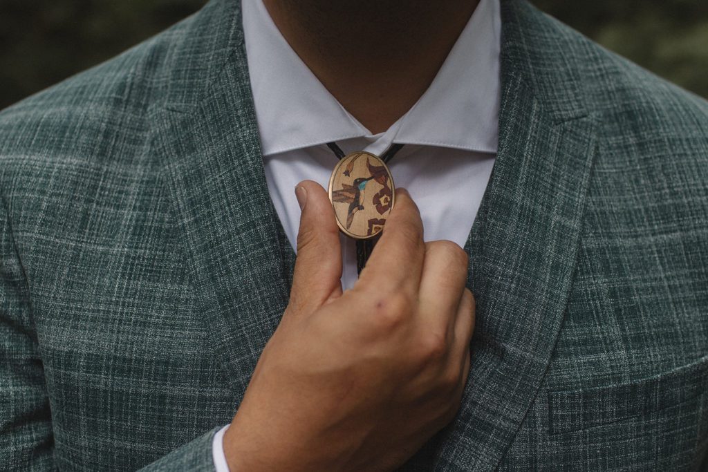 Groom adjusts bolo tie