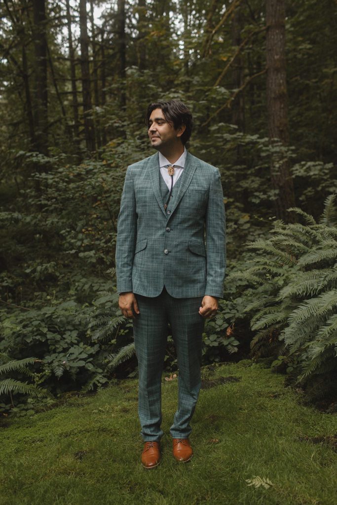 Groom poses in ASOS suit.