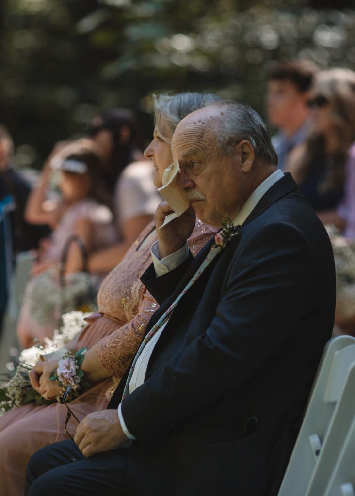 Dad cries while daughter reads vows at Dancing Deer Mountain wedding.