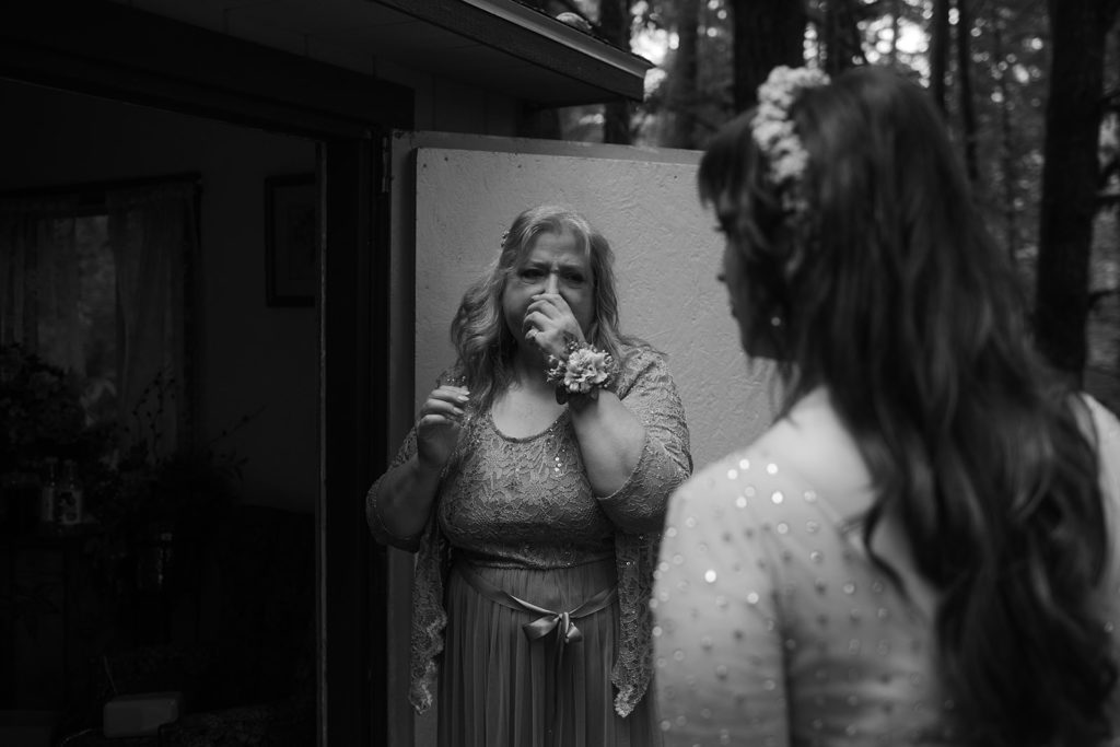 Mom cries while daughter is getting ready for wedding.