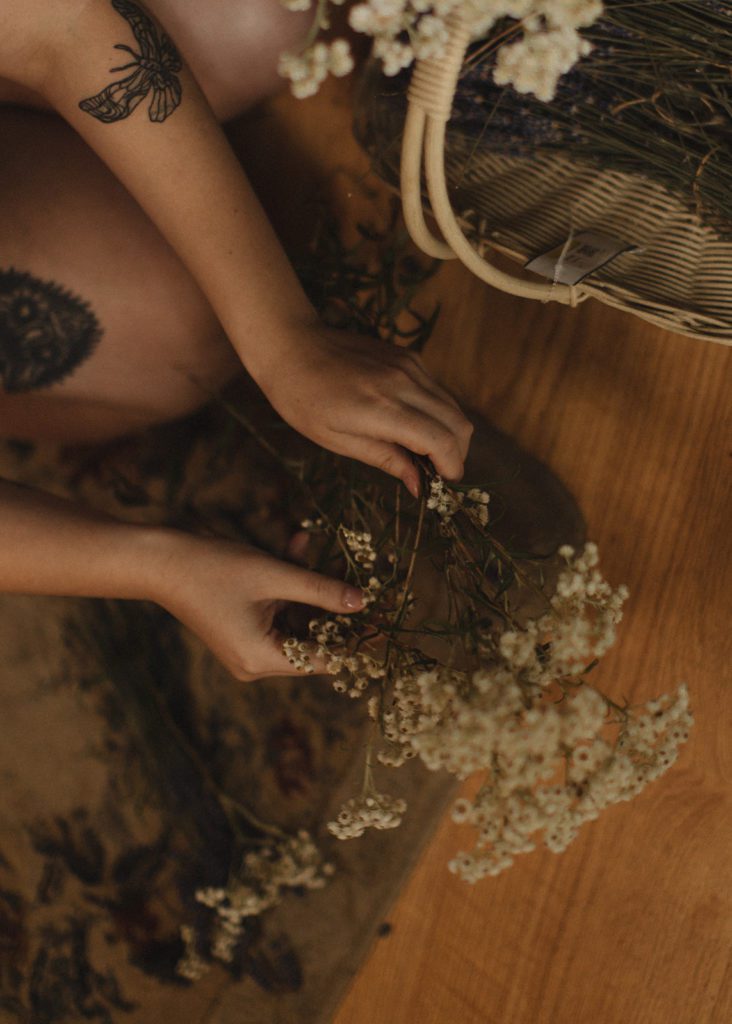 bride crafts bouquet before ceremony