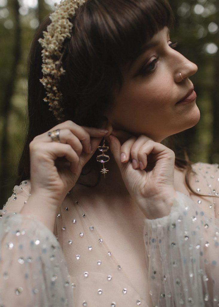 Bride puts on earrings