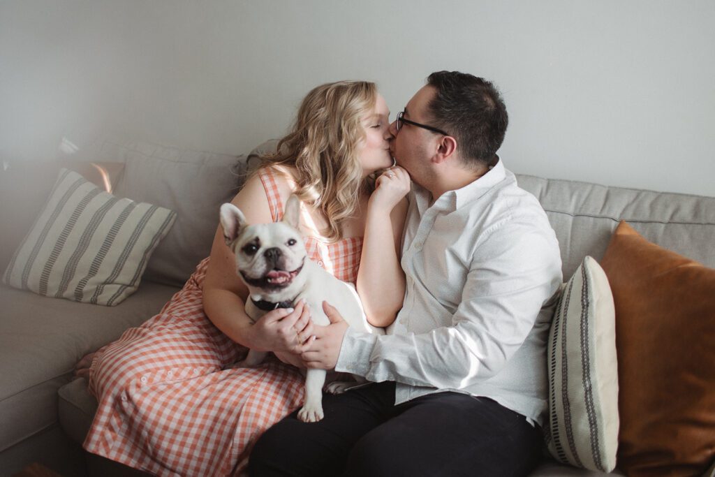 Couple kisses at neighborhood engagement session.