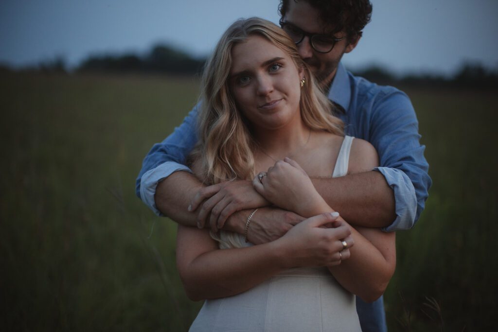 Couple embraces at blue hour engagement photos in Afton.