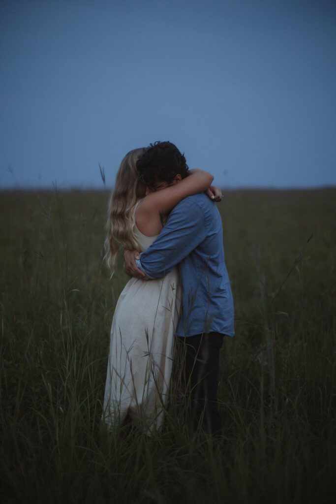 Couple embraces at blue hour engagement photos in Afton.