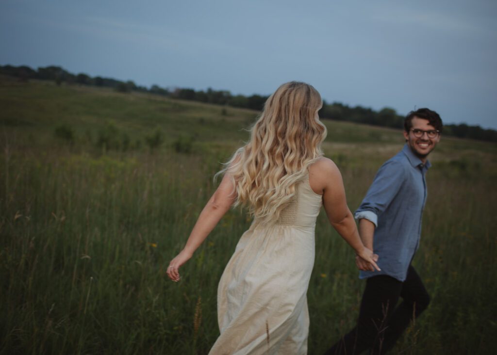 Couple runs at blue hour engagement photos in Afton.